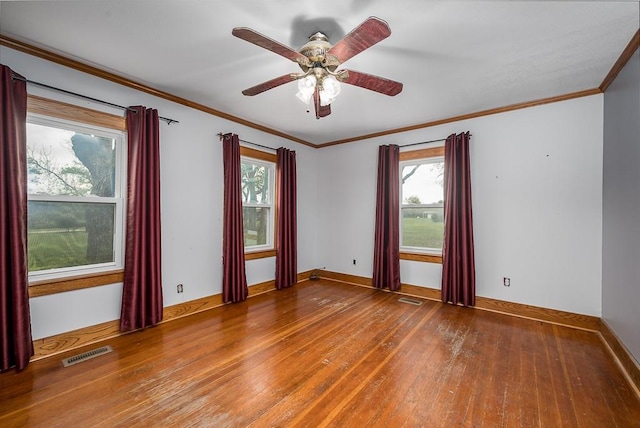 unfurnished room with wood-type flooring, ceiling fan, visible vents, and a wealth of natural light