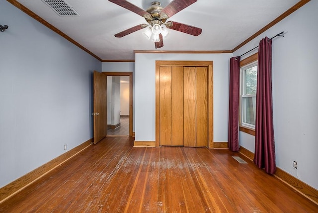 unfurnished bedroom with baseboards, visible vents, and hardwood / wood-style floors