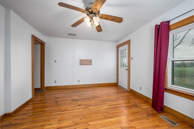 spare room featuring visible vents, a healthy amount of sunlight, and light wood-style floors