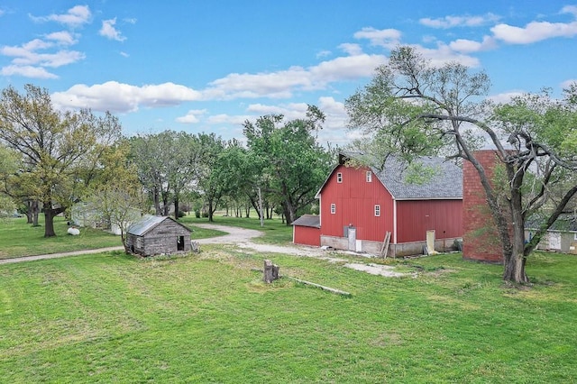 view of yard featuring a barn and an outbuilding
