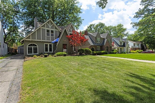 1275 W Gregory Blvd, Kansas City, MO 64114 - english style home with a chimney, a garage, a front lawn, and a residential view