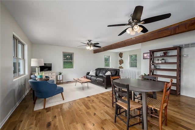 dining space featuring baseboards, a ceiling fan, and wood finished floors