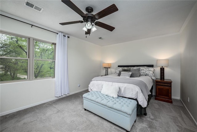 bedroom featuring crown molding, carpet floors, baseboards, and visible vents