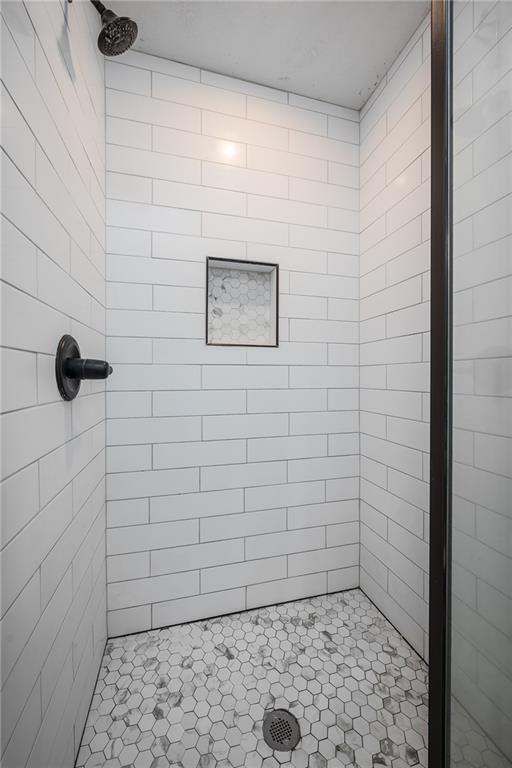 full bath with a shower stall