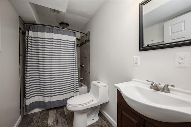 bathroom featuring visible vents, shower / bath combo, wood finished floors, vanity, and toilet
