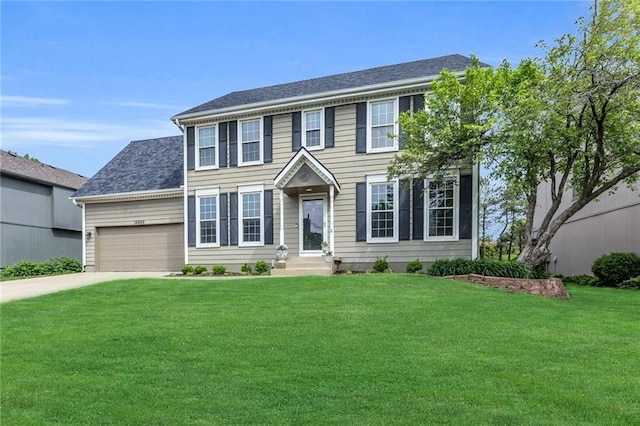 colonial inspired home featuring a garage, a front lawn, and concrete driveway