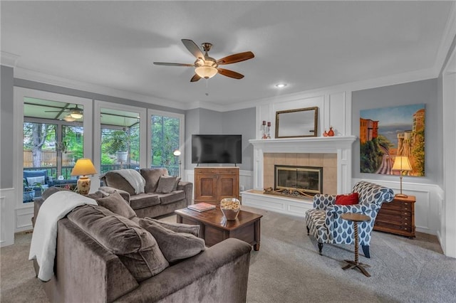 living area with carpet flooring, ceiling fan, and a decorative wall