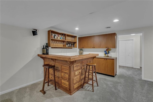 bar with recessed lighting, baseboards, a dry bar, and carpet