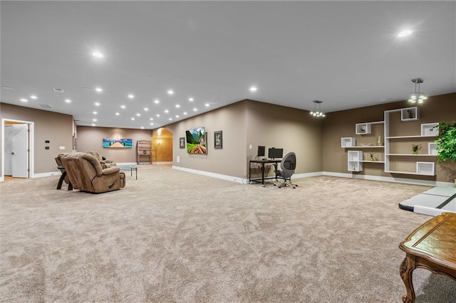 living room featuring arched walkways, baseboards, light carpet, and recessed lighting