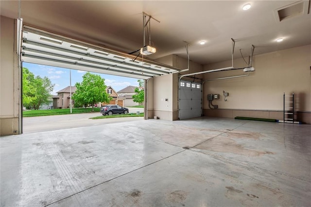 garage featuring visible vents and a garage door opener
