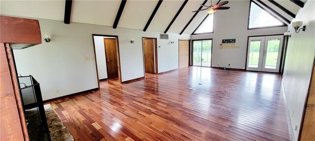 1620 Neosho St, Humboldt, KS 66748 - empty room with beam ceiling, high vaulted ceiling, ceiling fan, visible vents, and wood finished floors