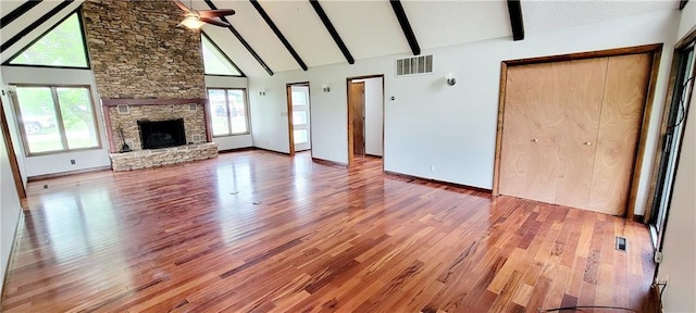 1620 Neosho St, Humboldt, KS 66748 - unfurnished living room with wood finished floors, beamed ceiling, visible vents, a ceiling fan, and high vaulted ceiling