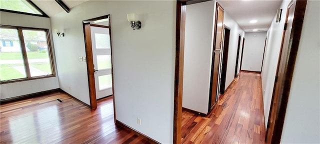 1620 Neosho St, Humboldt, KS 66748 - corridor featuring wood-type flooring, lofted ceiling with beams, and baseboards