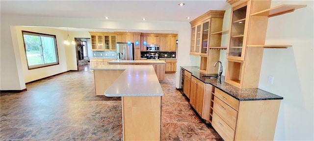 1620 Neosho St, Humboldt, KS 66748 - kitchen featuring a sink, stainless steel appliances, backsplash, a kitchen island, and baseboards