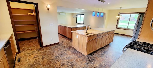 1620 Neosho St, Humboldt, KS 66748 - kitchen with a sink, baseboards, light countertops, refrigerator, and an island with sink