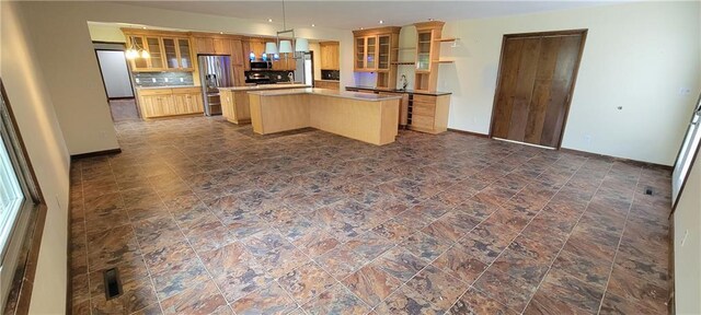 1620 Neosho St, Humboldt, KS 66748 - kitchen with glass insert cabinets, stone finish flooring, stainless steel appliances, a kitchen island, and backsplash