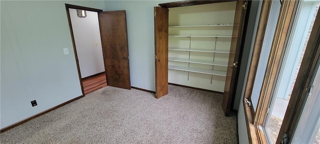 1620 Neosho St, Humboldt, KS 66748 - unfurnished bedroom with baseboards, a closet, and carpet flooring