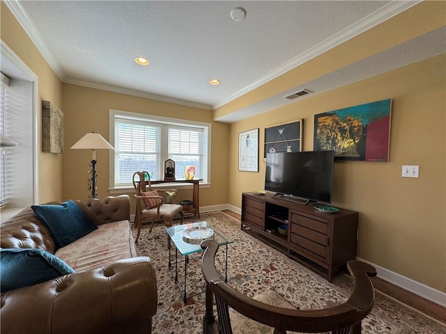 living area featuring crown molding, baseboards, visible vents, and wood finished floors
