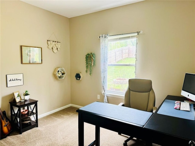 home office featuring a wealth of natural light, light colored carpet, and baseboards