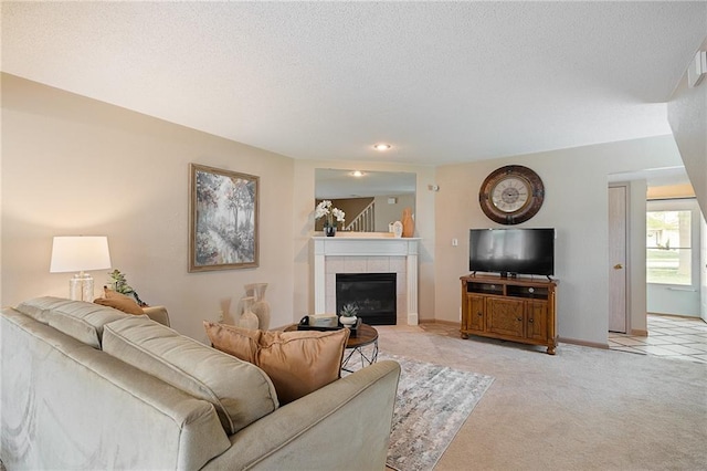 living room featuring light colored carpet, recessed lighting, baseboards, and a fireplace