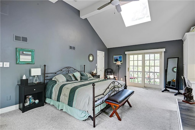 carpeted bedroom featuring visible vents, beam ceiling, a skylight, and high vaulted ceiling