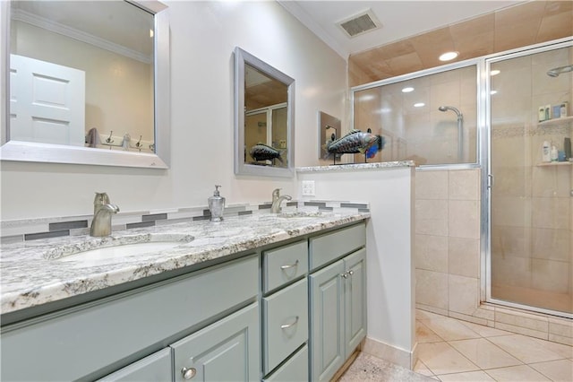 full bath featuring visible vents, a sink, and a shower stall