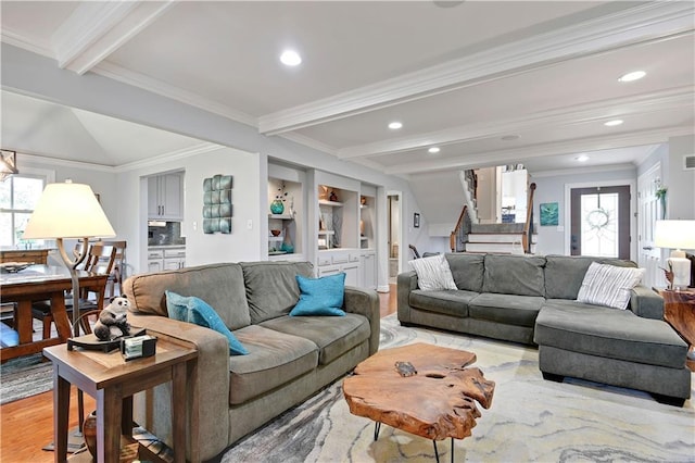 living area featuring stairs, beamed ceiling, plenty of natural light, and light wood-style floors