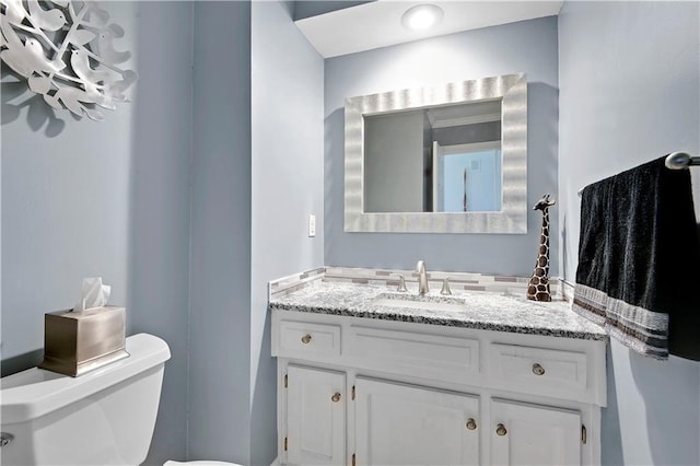 half bath with vanity and toilet