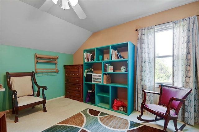 sitting room with carpet floors, ceiling fan, and vaulted ceiling