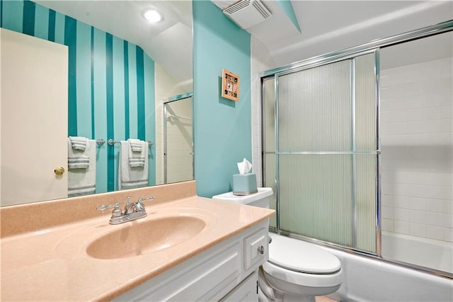 bathroom featuring shower / bath combination with glass door, vanity, toilet, wallpapered walls, and visible vents