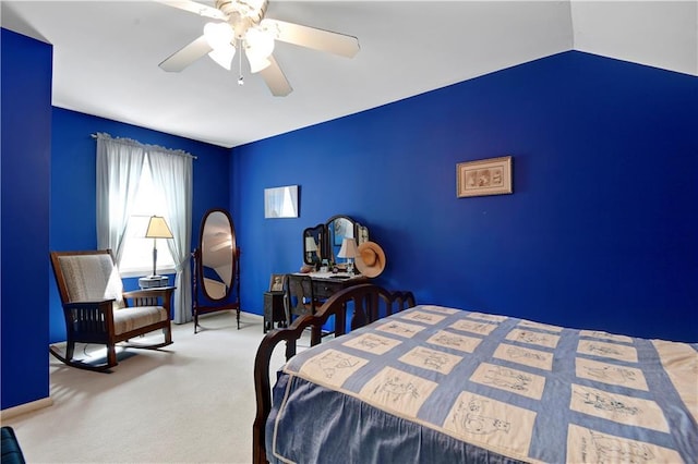 carpeted bedroom featuring baseboards and a ceiling fan
