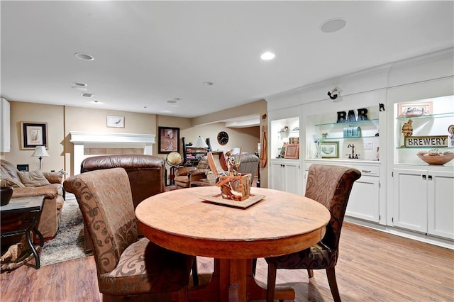 dining area with recessed lighting and light wood finished floors