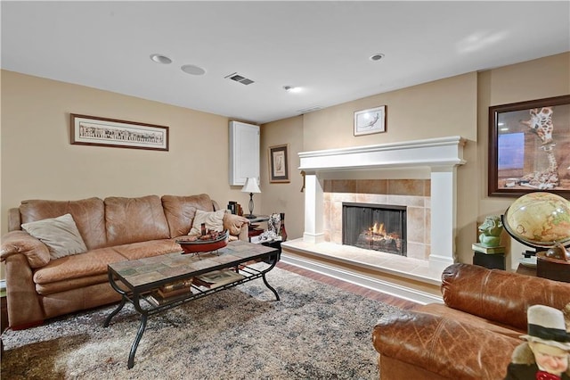 living room featuring visible vents, recessed lighting, wood finished floors, and a tile fireplace