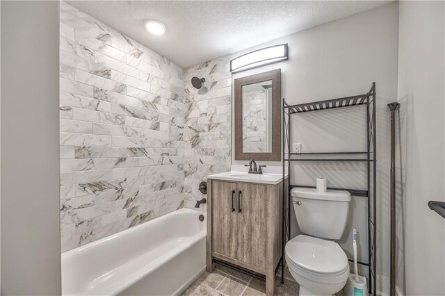full bath with toilet, a textured ceiling, shower / bathing tub combination, and vanity
