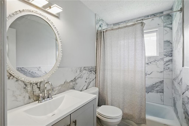 5900 Westridge Rd, Kansas City, MO 64133 - full bath with tile walls, toilet, vanity, shower / bath combo with shower curtain, and a textured ceiling