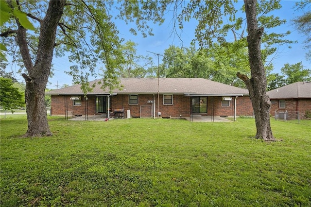 5900 Westridge Rd, Kansas City, MO 64133 - back of house featuring a patio area and brick siding