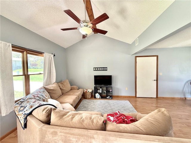 living room with light wood finished floors, a textured ceiling, a ceiling fan, baseboards, and lofted ceiling
