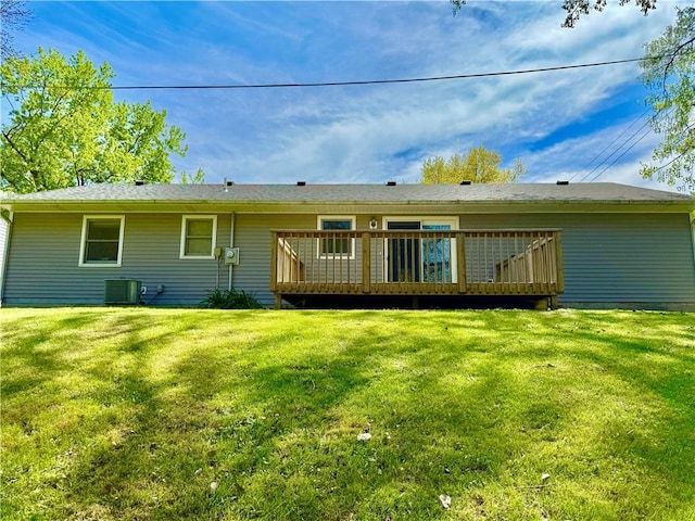 back of house with a lawn, central air condition unit, and a deck