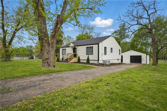 2640 S 53rd St, Kansas City, KS 66106 - bungalow-style home featuring an outbuilding, a front yard, driveway, and a garage