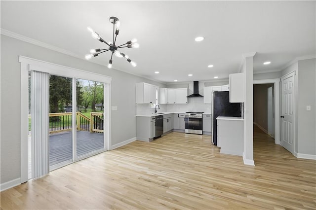 2640 S 53rd St, Kansas City, KS 66106 - kitchen with stainless steel appliances, an inviting chandelier, ornamental molding, and wall chimney range hood