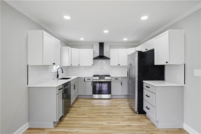 2640 S 53rd St, Kansas City, KS 66106 - kitchen with light wood-style flooring, wall chimney exhaust hood, appliances with stainless steel finishes, and crown molding