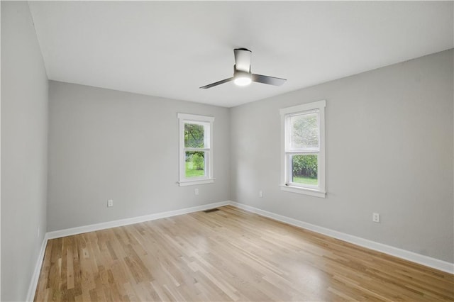 2640 S 53rd St, Kansas City, KS 66106 - unfurnished room with baseboards, light wood-type flooring, visible vents, and a ceiling fan