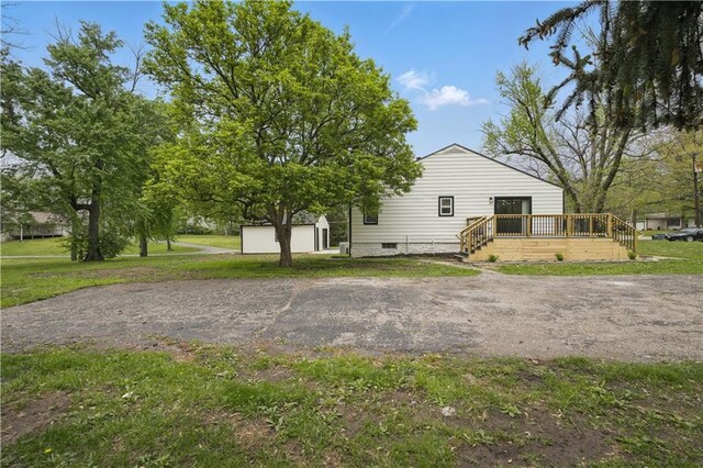 2640 S 53rd St, Kansas City, KS 66106 - exterior space with a wooden deck, crawl space, an outdoor structure, a yard, and a shed