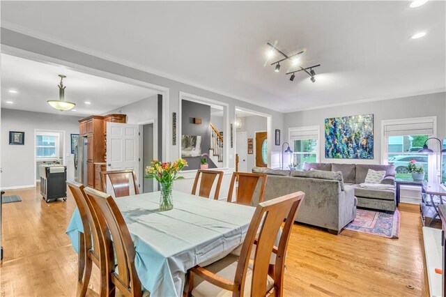 dining room featuring stairs, recessed lighting, crown molding, and light wood-style floors