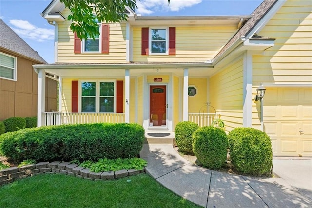 12606 Slater St, Overland Park, KS 66213 - view of exterior entry featuring a porch and a garage
