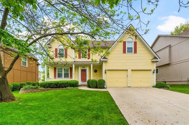 12606 Slater St, Overland Park, KS 66213 - traditional-style house with concrete driveway, a front lawn, covered porch, and an attached garage