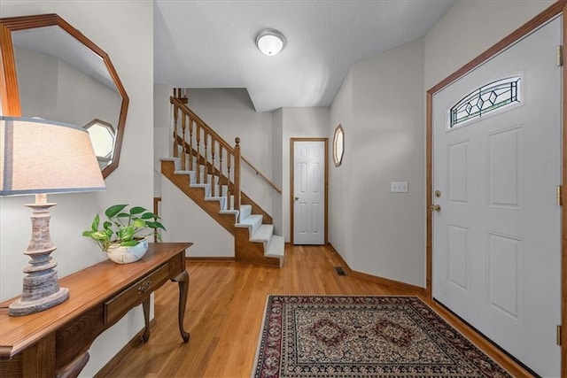 12606 Slater St, Overland Park, KS 66213 - entrance foyer featuring stairs and light wood-style floors
