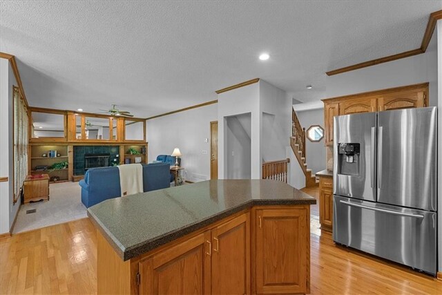 12606 Slater St, Overland Park, KS 66213 - kitchen featuring stainless steel fridge, a ceiling fan, crown molding, a textured ceiling, and light wood-style floors