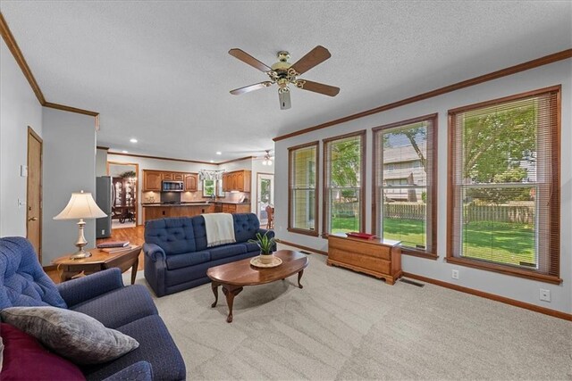 12606 Slater St, Overland Park, KS 66213 - living room featuring crown molding, a ceiling fan, a textured ceiling, and light colored carpet