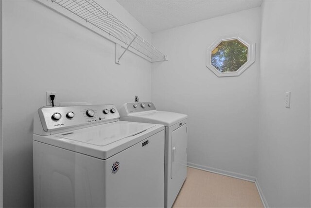 12606 Slater St, Overland Park, KS 66213 - washroom featuring washer and dryer and baseboards